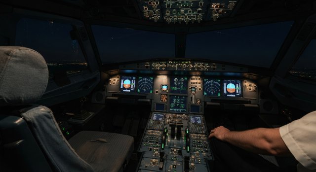 Ein dunkles Cockpit eines Airbus A320 in einem Flugsimulator während des Startvorgangs.